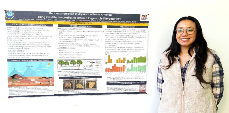 Isabel Torres next to her poster